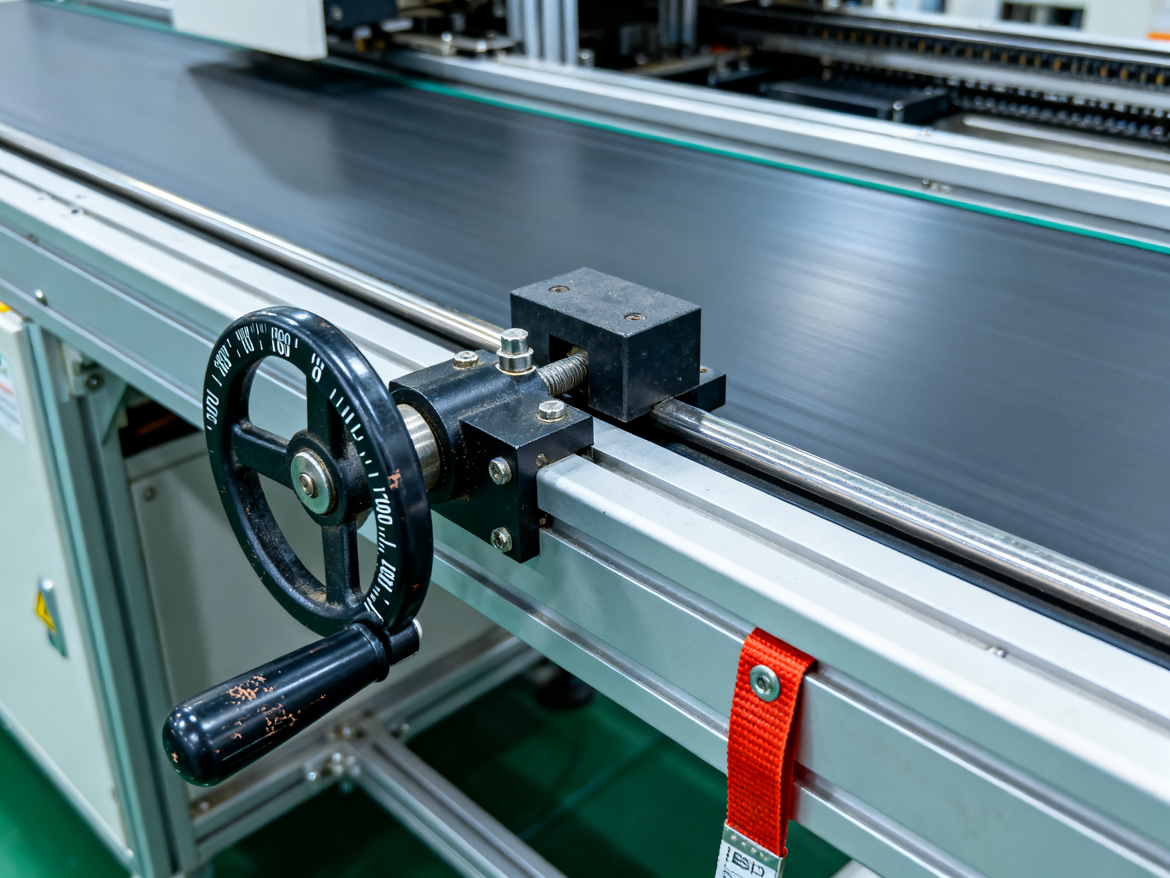 SMT Conveyor Belts: A Comprehensive Guide to Types, Features, Market Trends, and 2026 Insights2 - S&M Co.Ltd Close up detail of width adjustable conveyor rail mechanism in an SMT facility for flexible PCB handling.