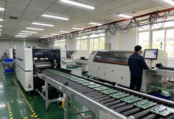 1787900663-wide-documentary-shot-of-an-smt-production-line-in-an-electronics-factory-stenci-1787900660910